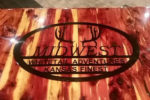 Photo of Midwest Whitetail Adventures logo on table